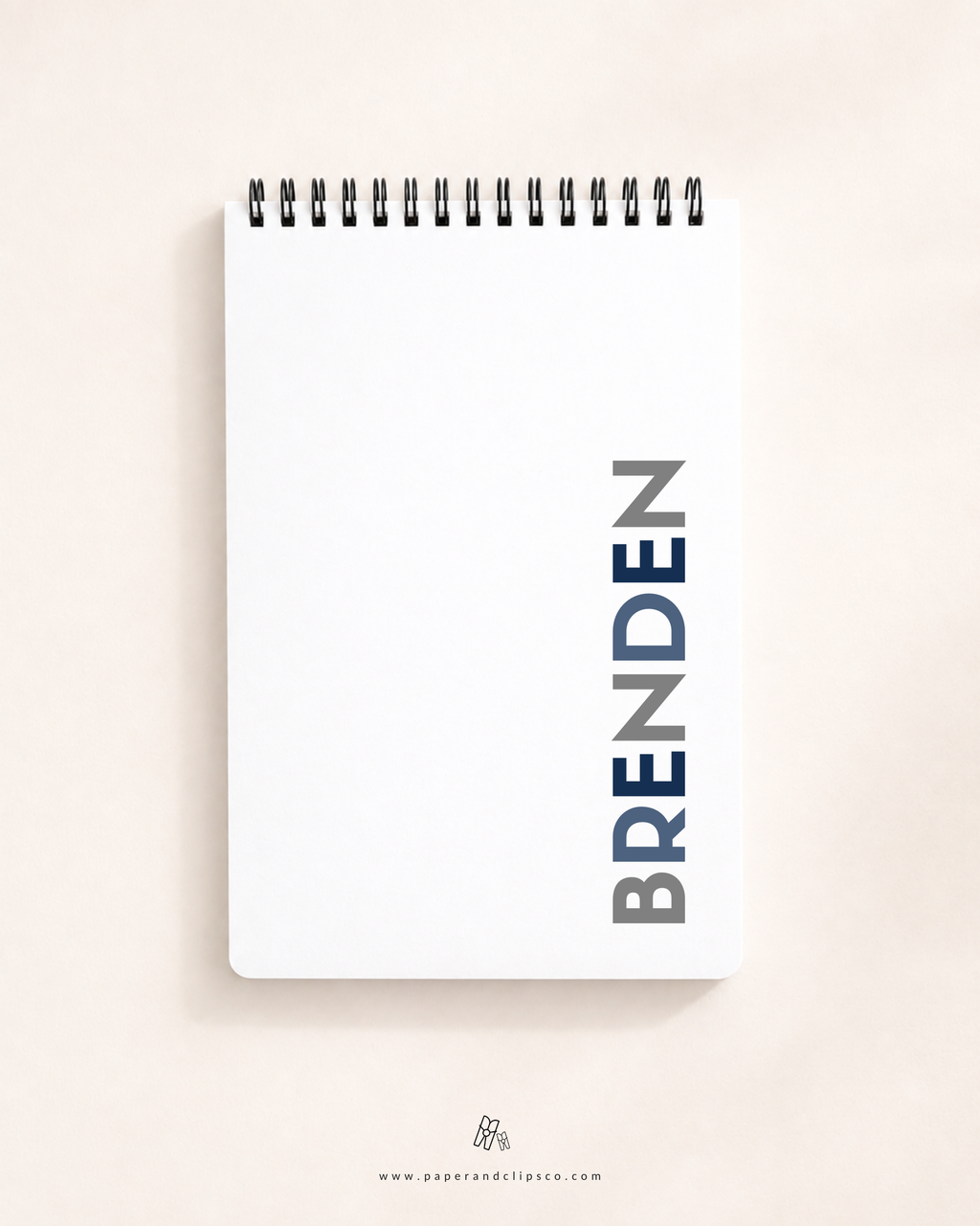 Personalized soft cover top-spiral daily planner featuring custom name "BRENDEN" printed vertically on a clean white cover.