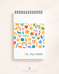 Soft cover personalized 48-page top-spiral teacher daily planner with colorful doodle design and custom text.