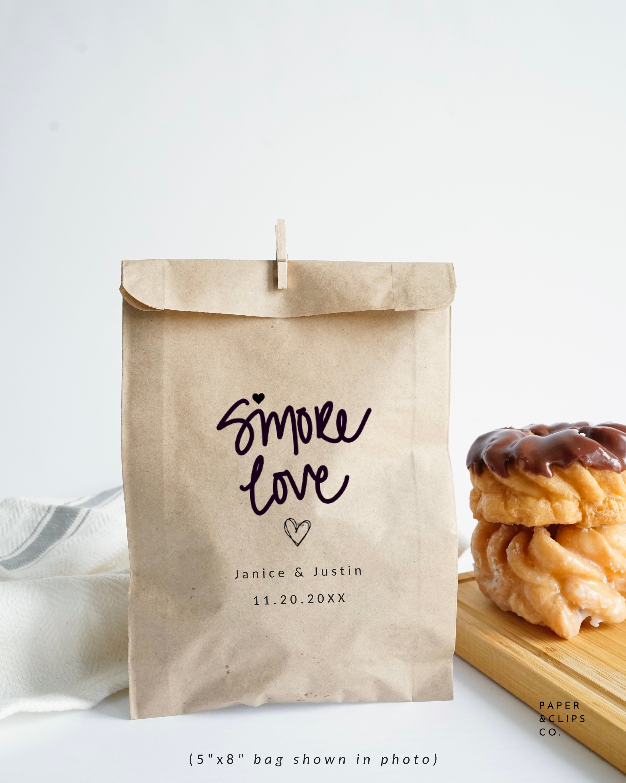 Personalized paper favor bag, laser printed with our signature hand lettering “s'more love” and custom names and date below. Perfect for s'more favors!