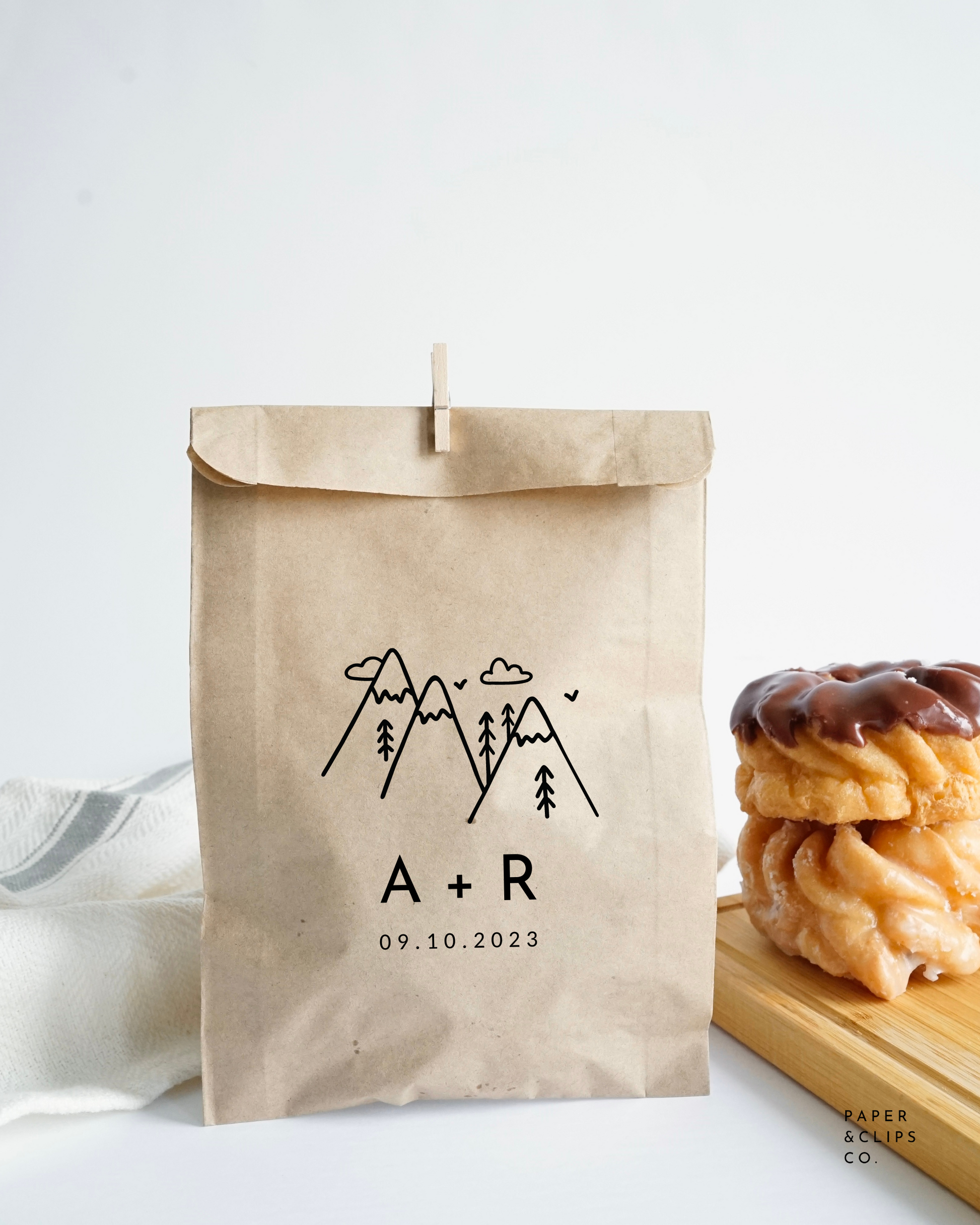 Personalized paper favor bag, with laser printed mountain image and custom initials and date or message below.