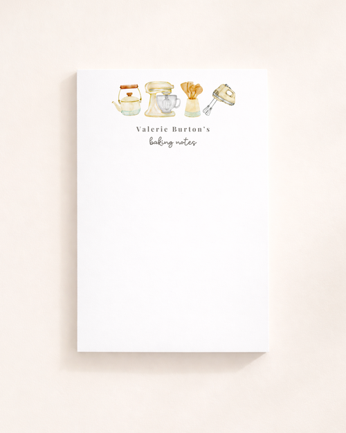 A vertical white notepad featuring watercolor illustrations of a tea kettle, stand mixer, wooden spoons, and a hand mixer.
